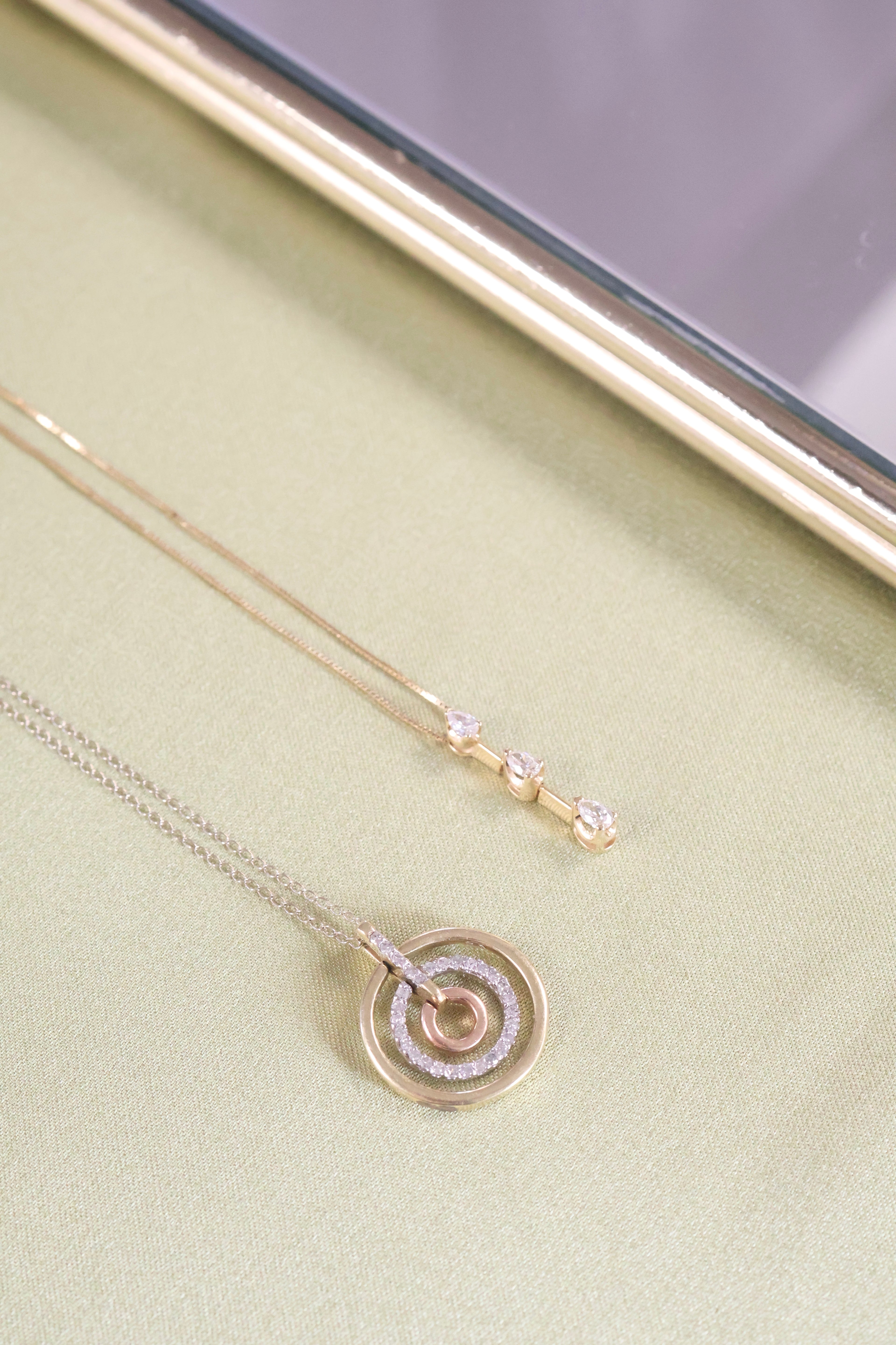 Three-Tone Solid Gold Circle Pendant with 1/3ct. t.w. Cut Diamonds
