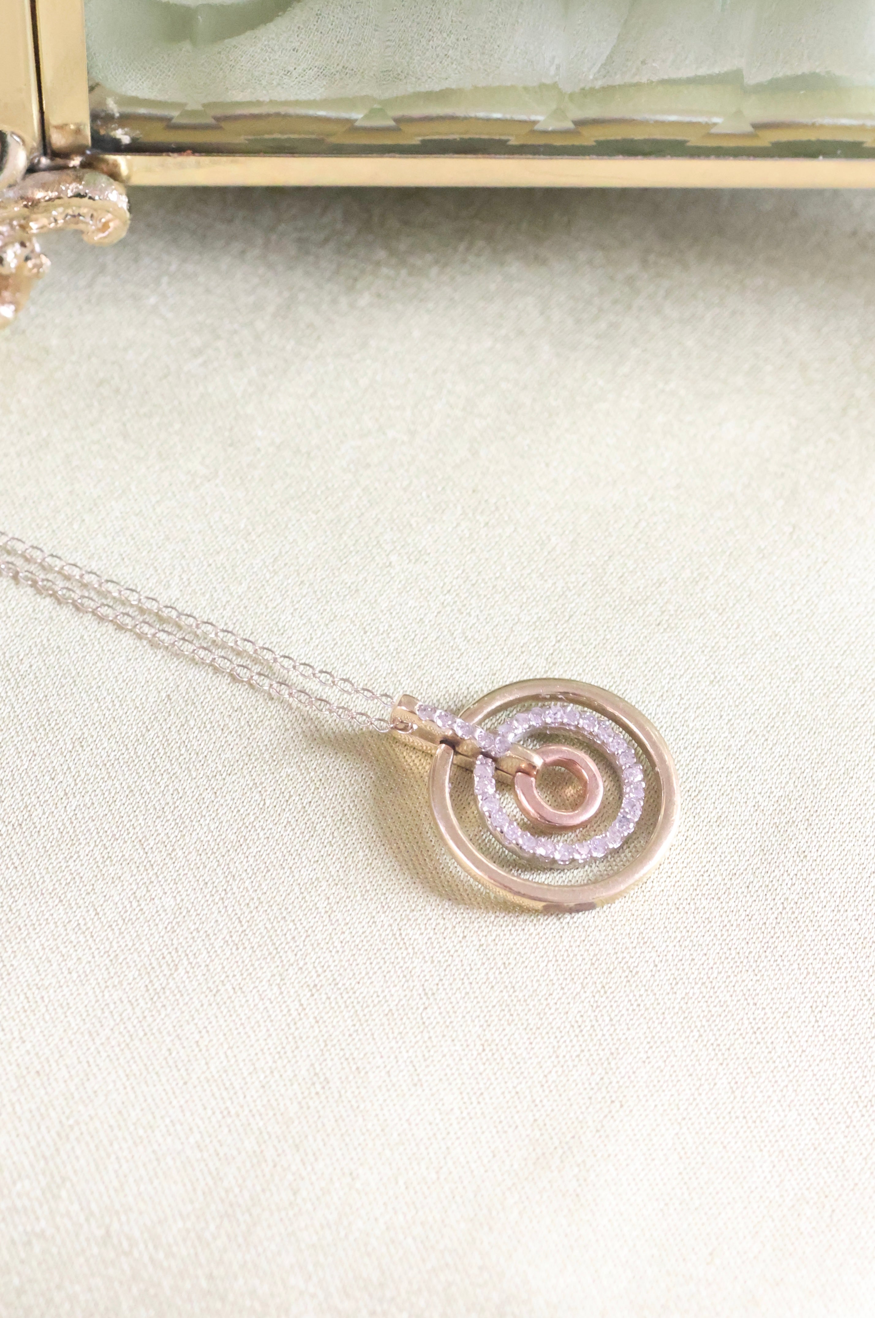 Three-Tone Solid Gold Circle Pendant with 1/3ct. t.w. Cut Diamonds
